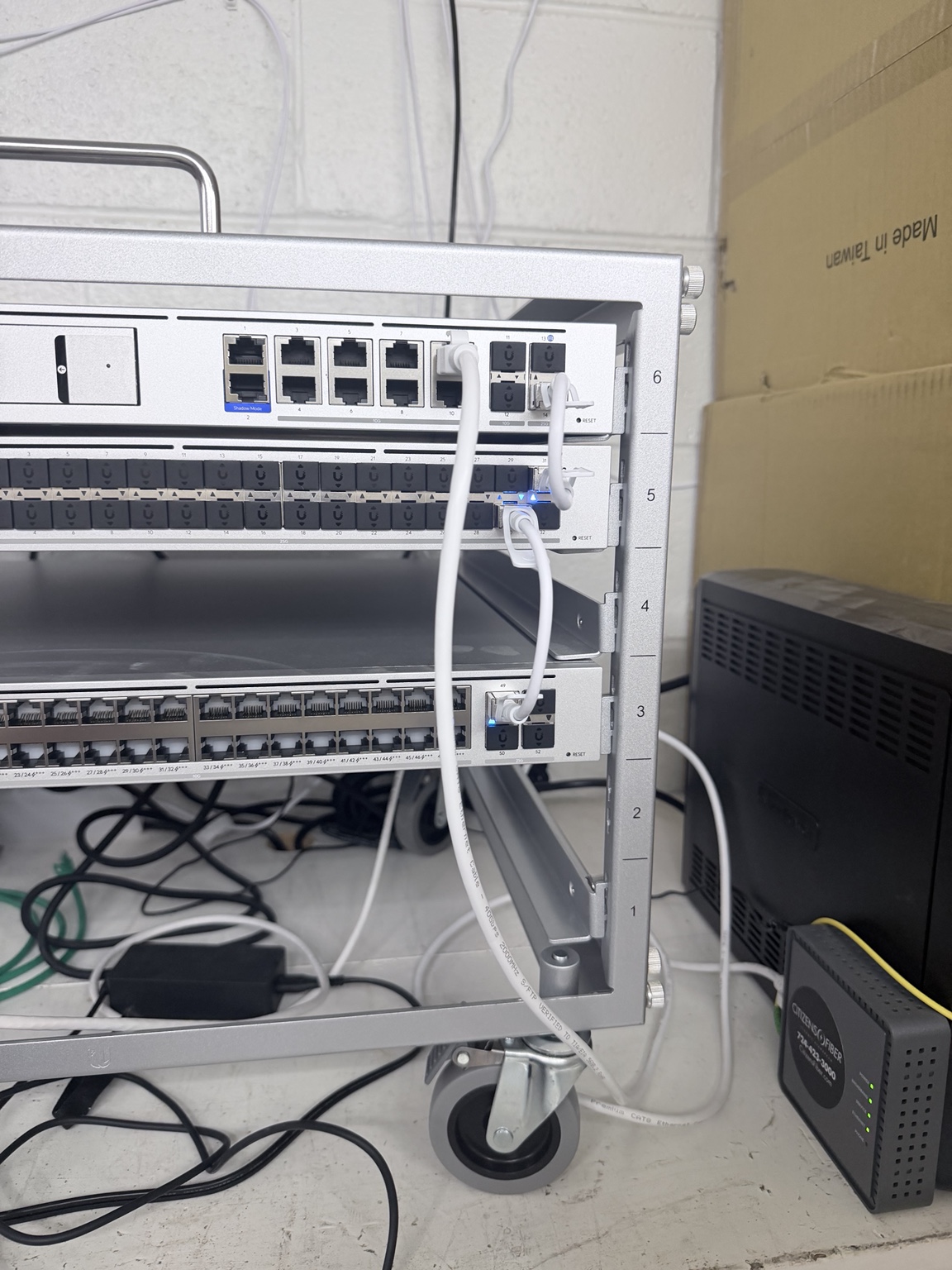 Compact Shadow Rack holding a UniFi gateway, aggregation switch, and network switch connected for testing